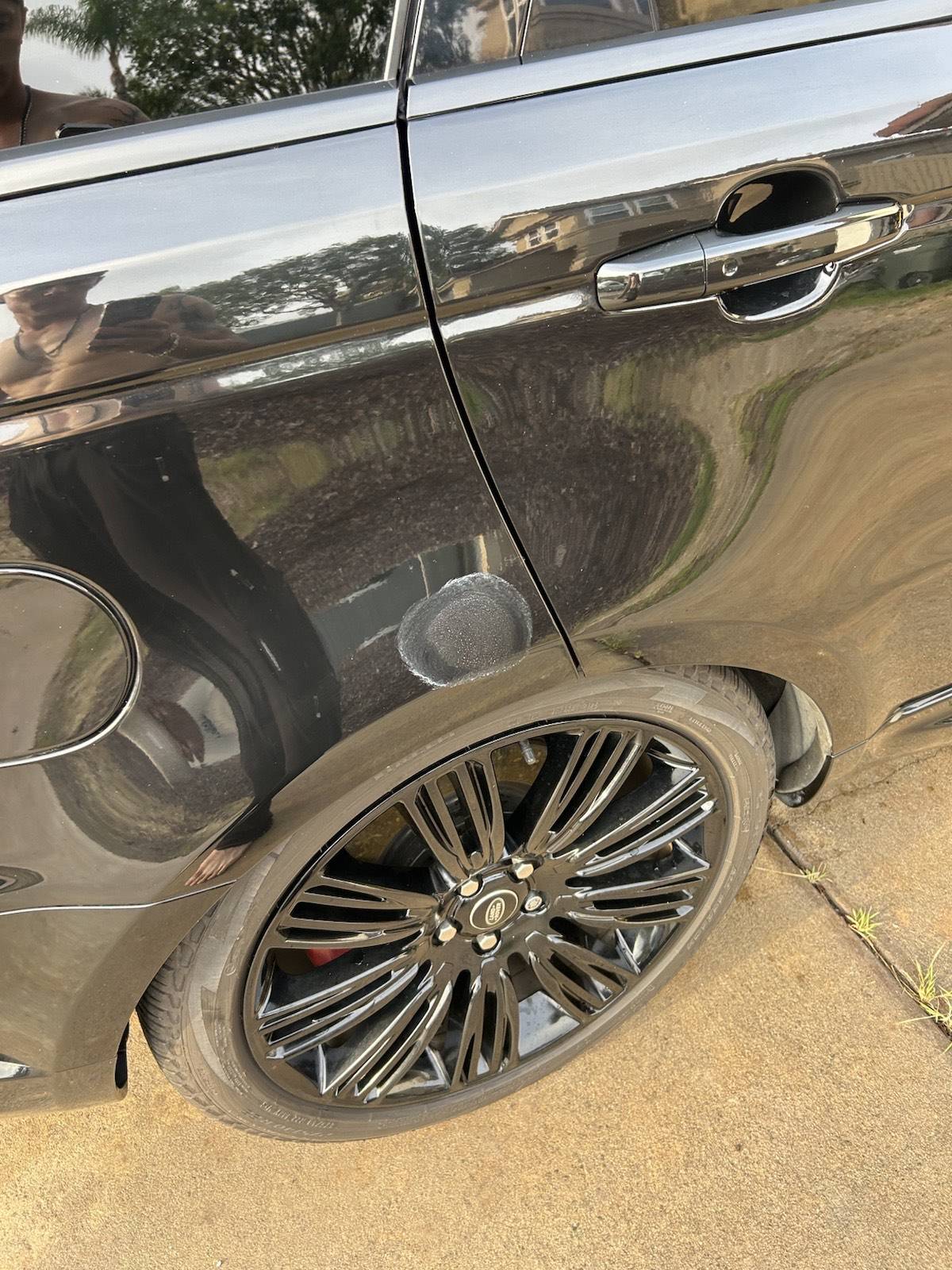 Close-up of a clean, glossy Range Rover wheel and tire after mobile detailing